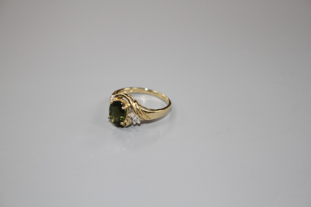 A modern 9ct gold, olive green paste and diamond set dress ring, size S, gross weight 3.2 grams.